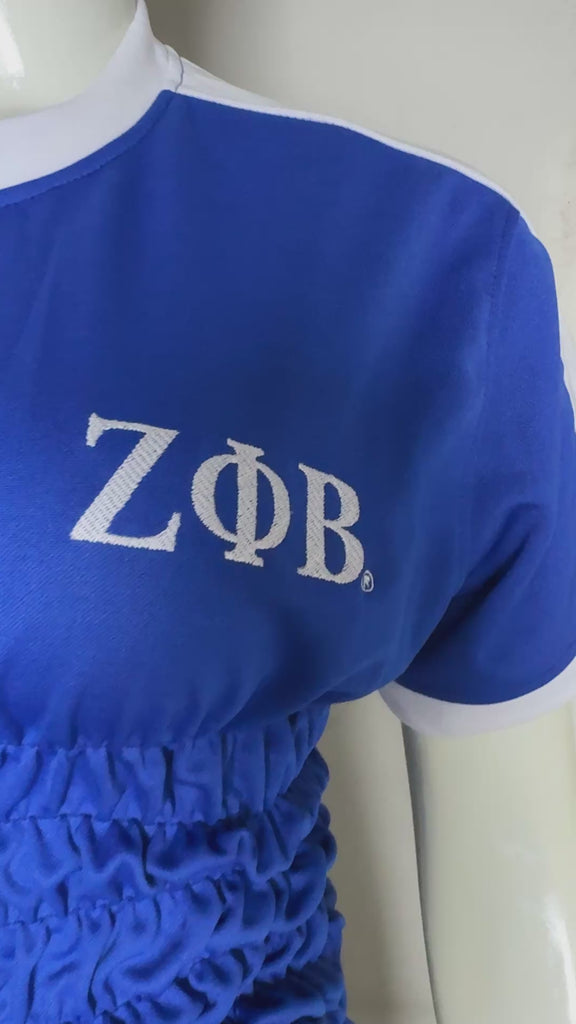 Royal blue Zeta Phi Beta athletic style top shown on mannequin against gray wall